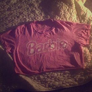 A pink barbie crop top with 1980s barbie logo
